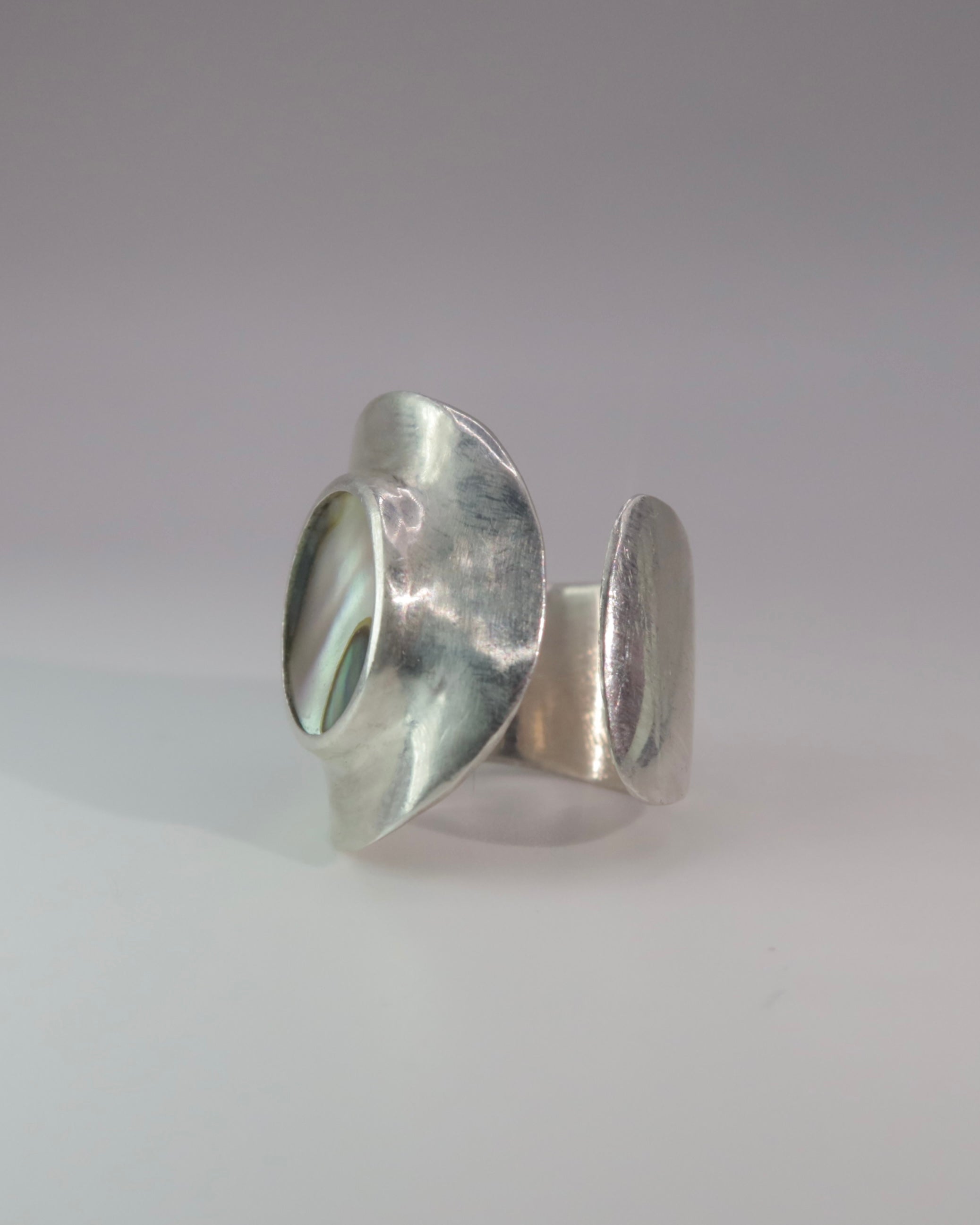 Silver ring on a light gray background