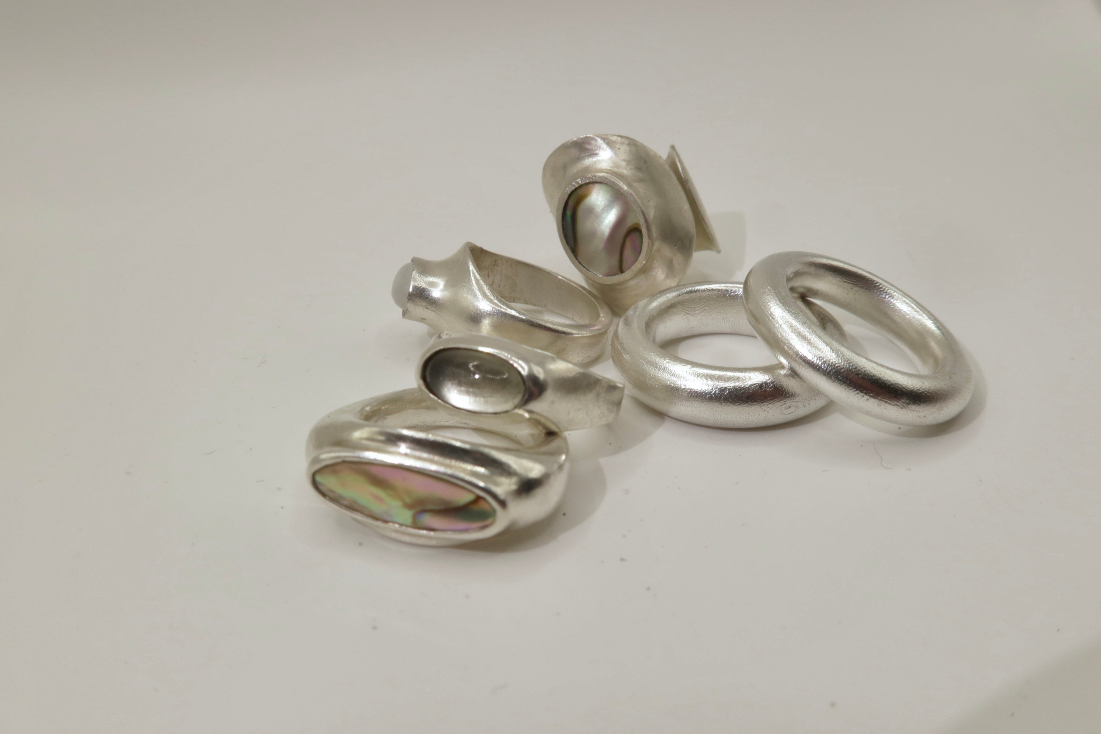 Silver rings on a light gray surface