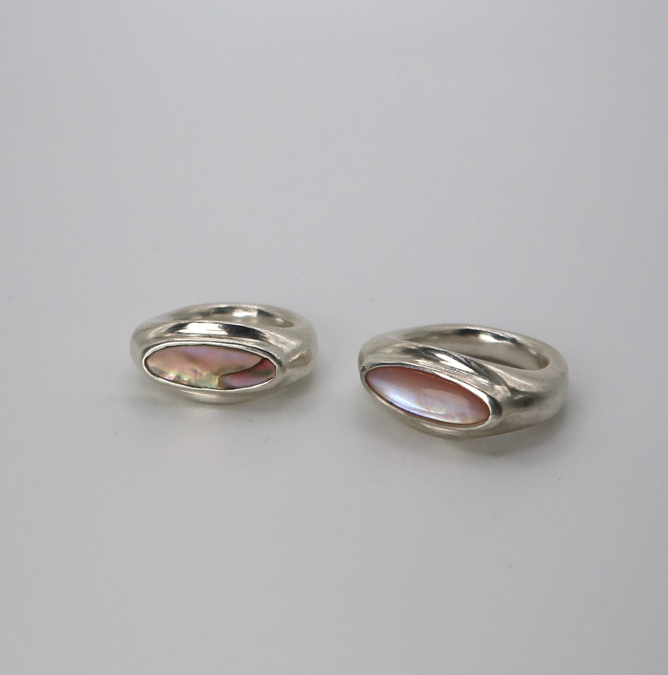 Two silver rings on a light gray background