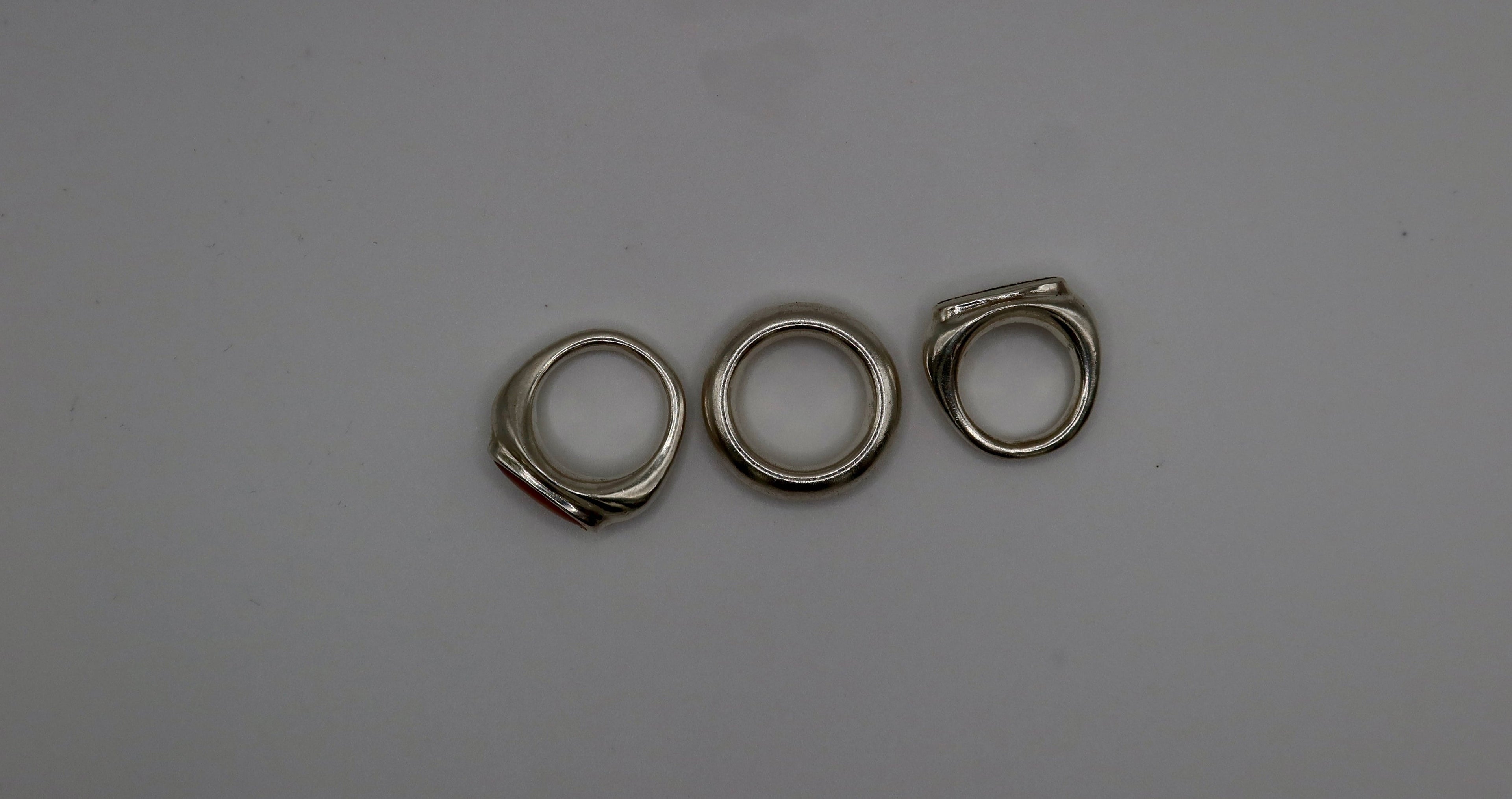 Three metal rings on a gray background